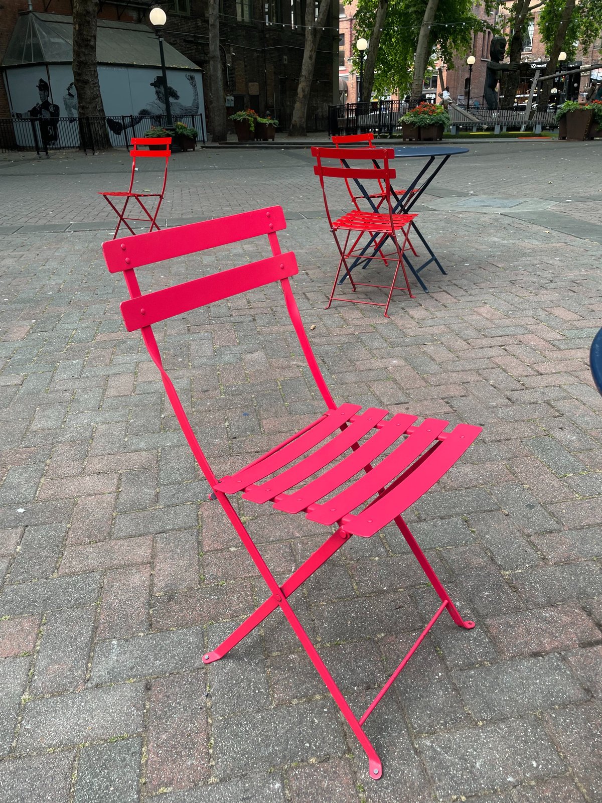 Red folding chairs scattered in Occidental Park