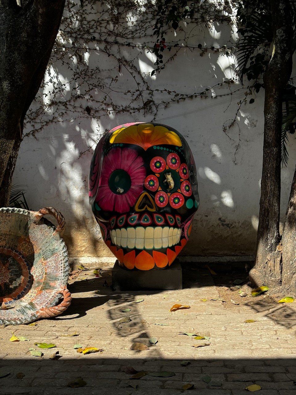 Sugar skull sculpture sits on a patio
